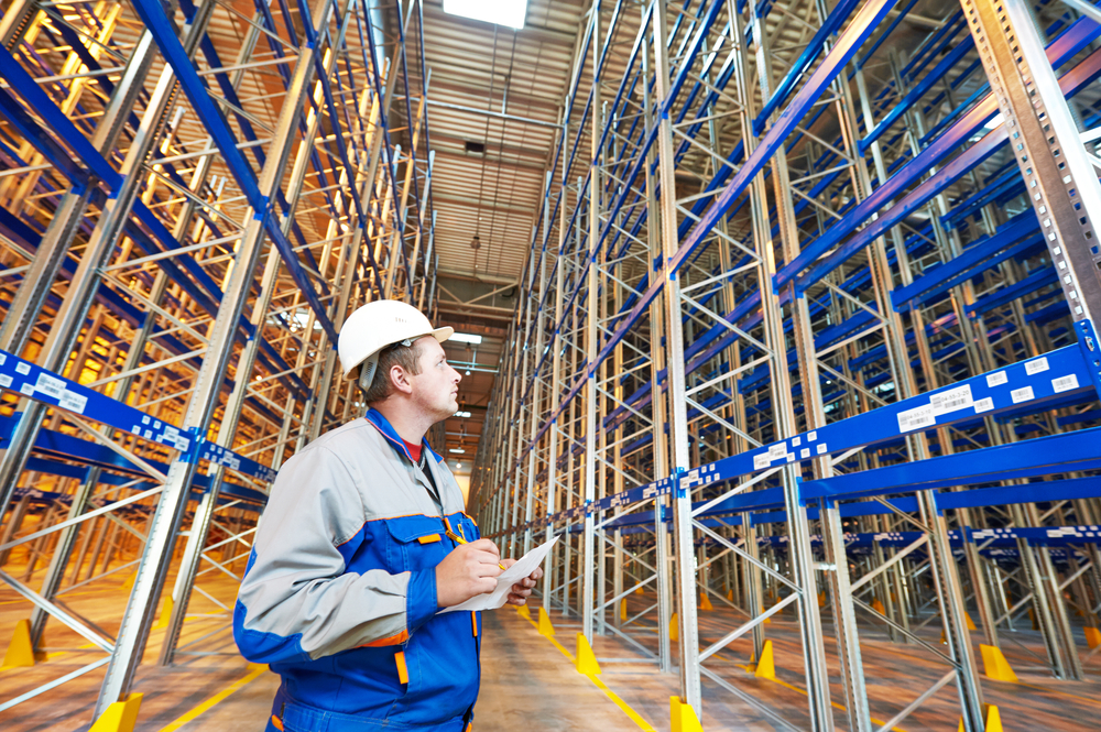 Two,Warehouse,Worker,In,Front,Of,Rack,Stack,In,Storehouse
